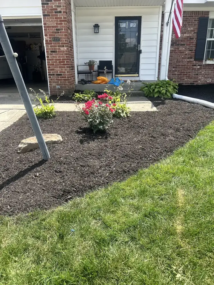 Front porch flower bed refreshed with dark mulch