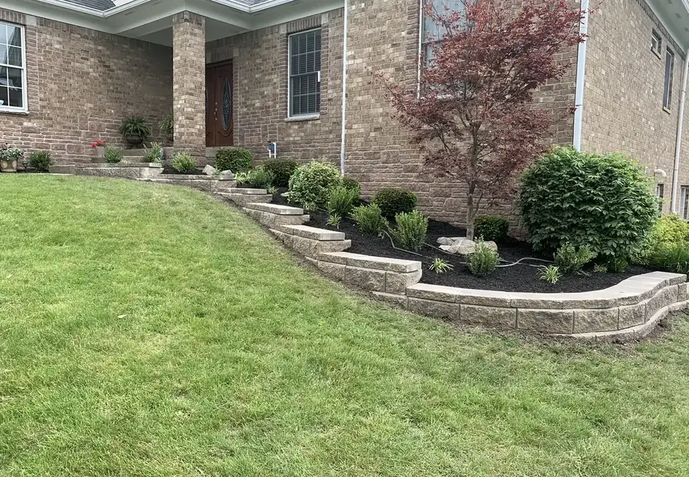 Tiered block retaining wall with a planting bed in a front yard