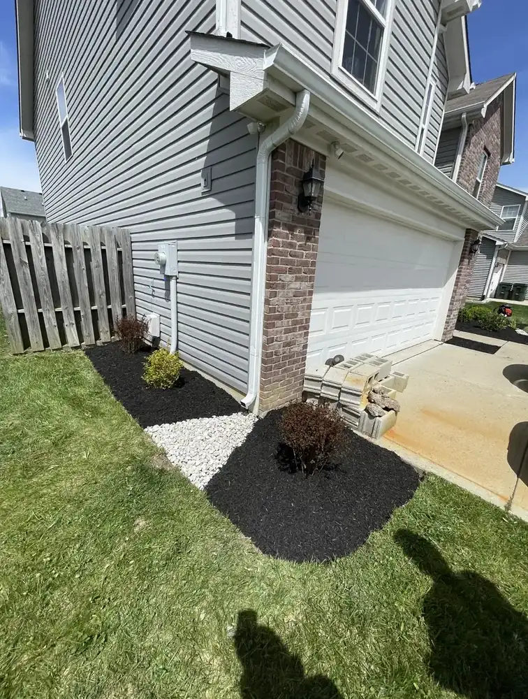 Side yard bed refreshed with dark mulch and a new edge