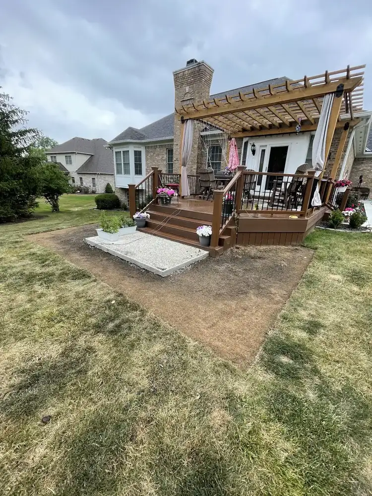 Backyard area beside a pergola prepared for new sod by J’s Design